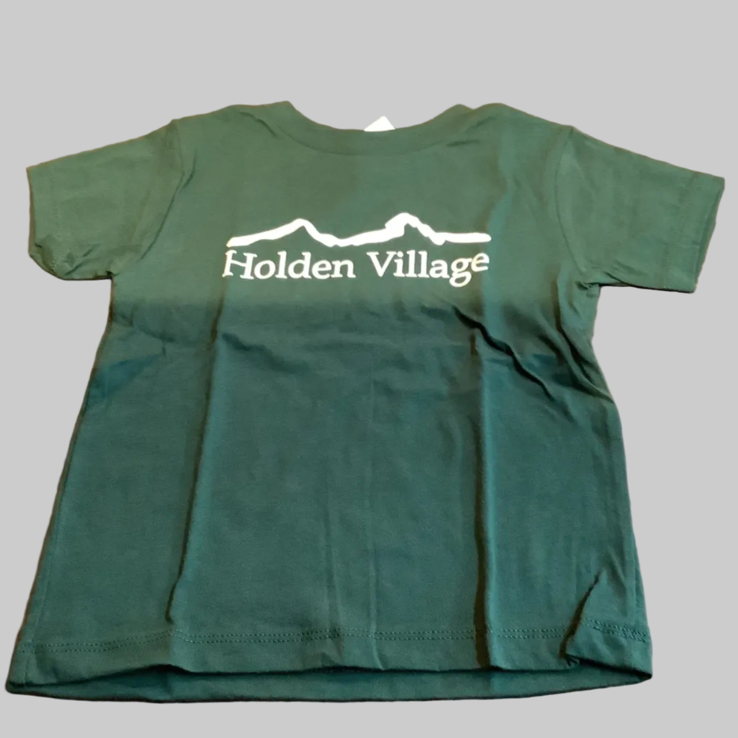 Green t-shirt with 'Holden Village' printed on it