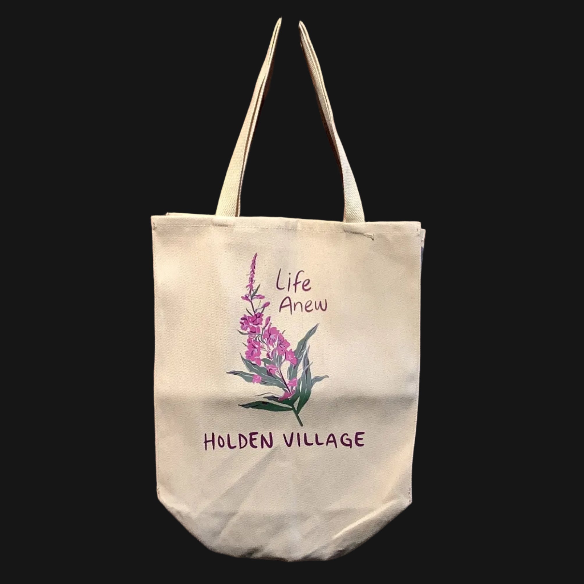 Tote bag with floral design and text hanging on a pegboard