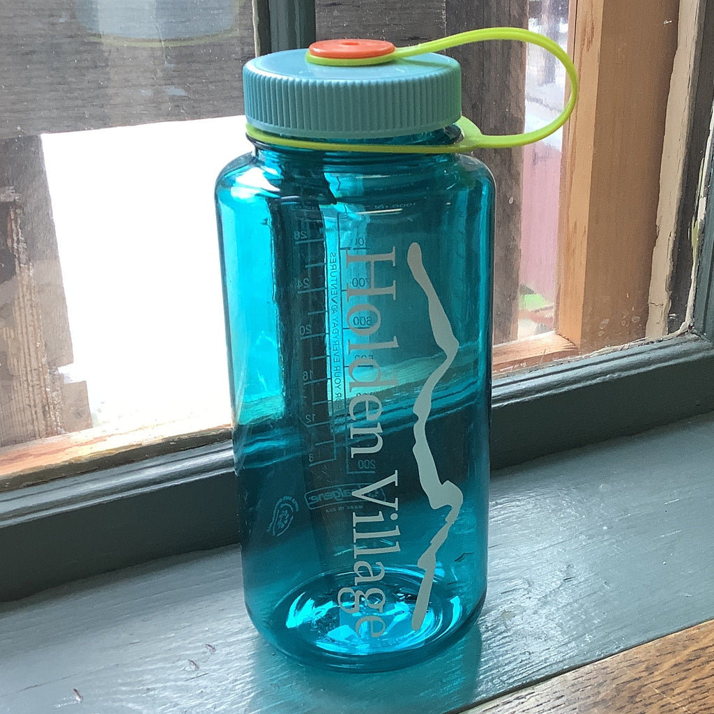 A translucent teal blue water bottle with a light blue cap and a lime green loop strap.