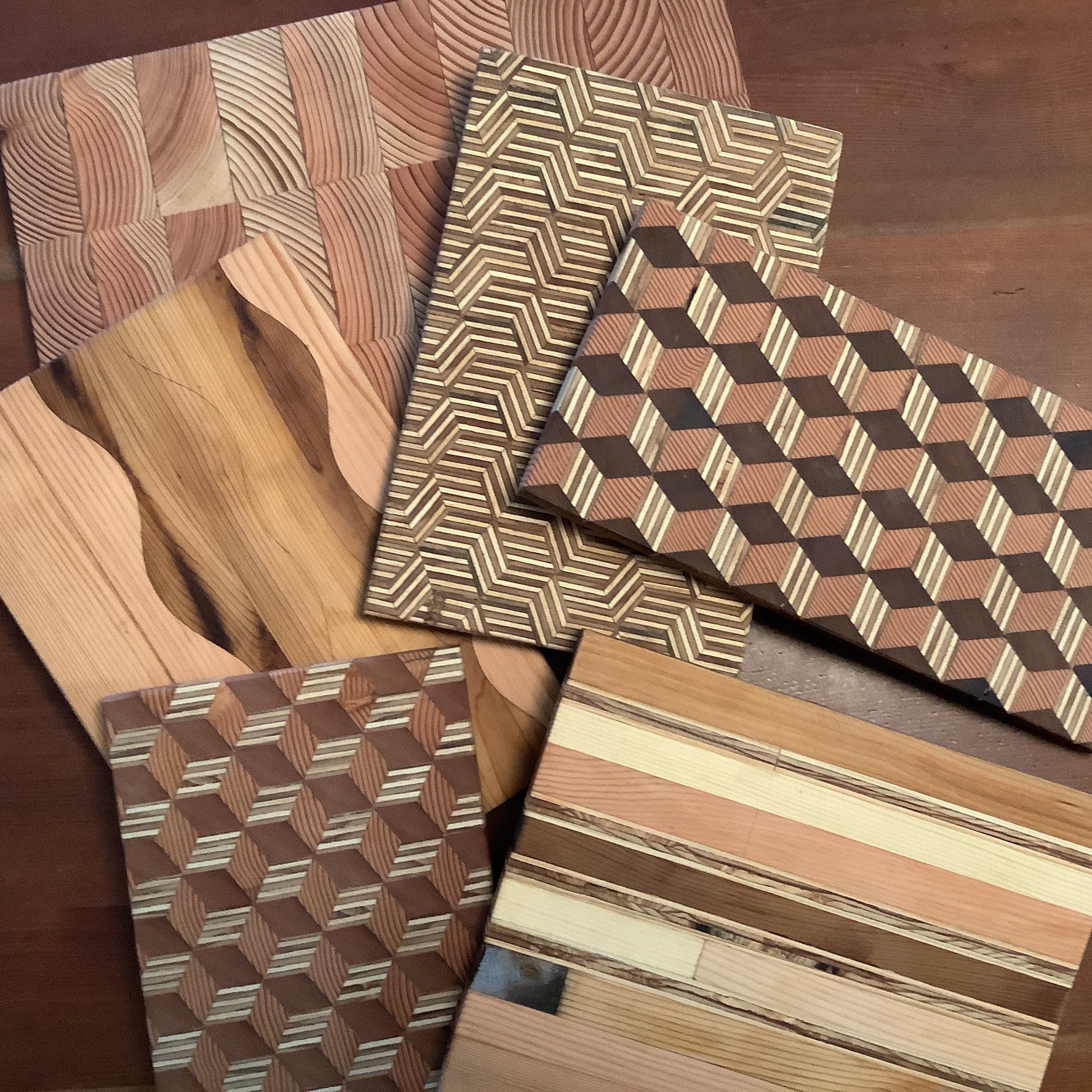 Collection of wooden samples with various patterns on a wooden surface